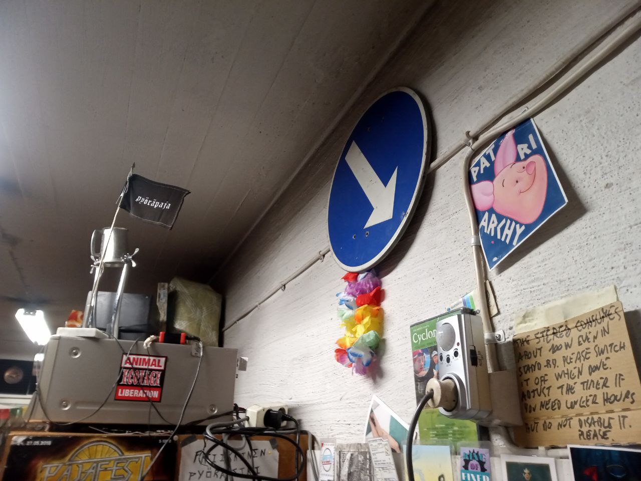 A shelf with a sound system on top, connected to a power socket with a timer connected to a motion sensor